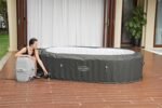 Bestway® Lay-Z-SPA® XXL-Whirlpool Mauritius AirJet™ mit App-Steuerung, für 7 Personen Ø 270 x 180 x 71 cm, Holz-Optik (Basaltgrau)